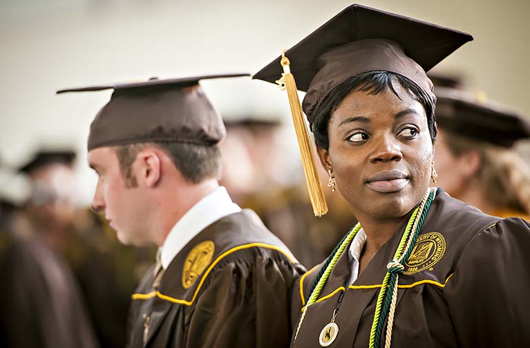 students wearing graduation regalia