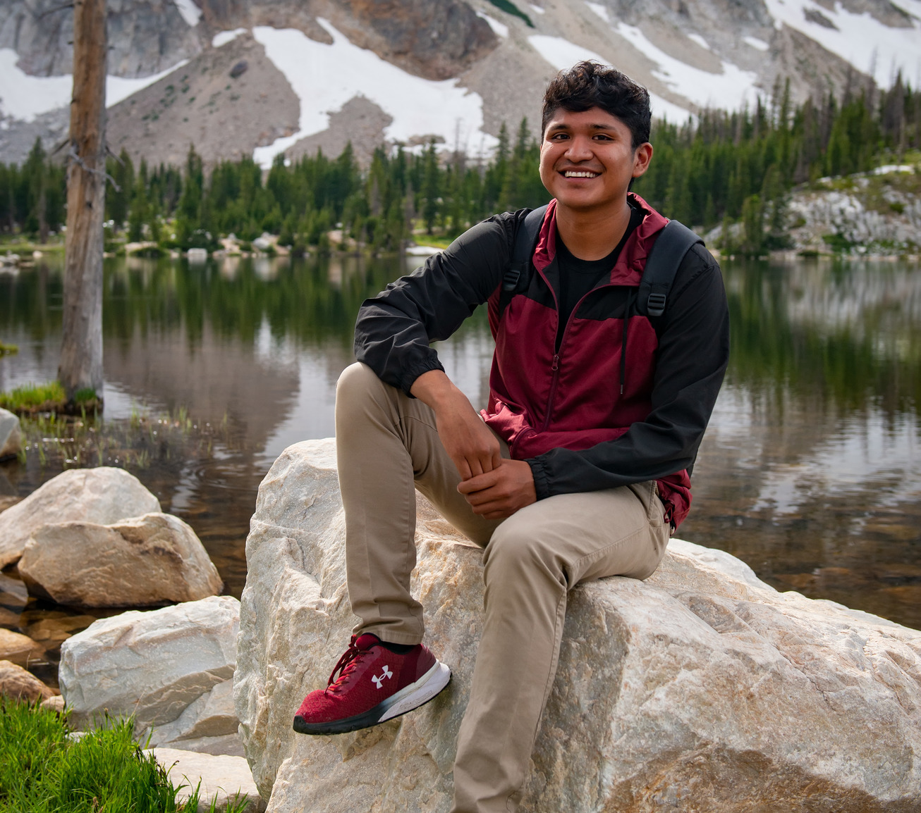 A student smiles for a picture in by Mirror Lake