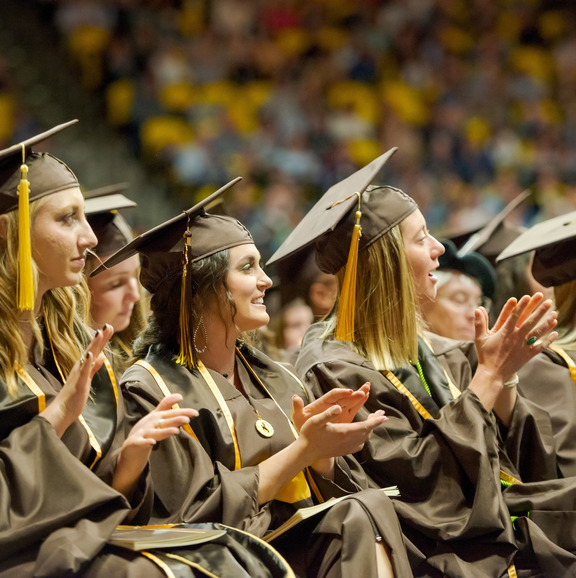 students applauding at graduation
