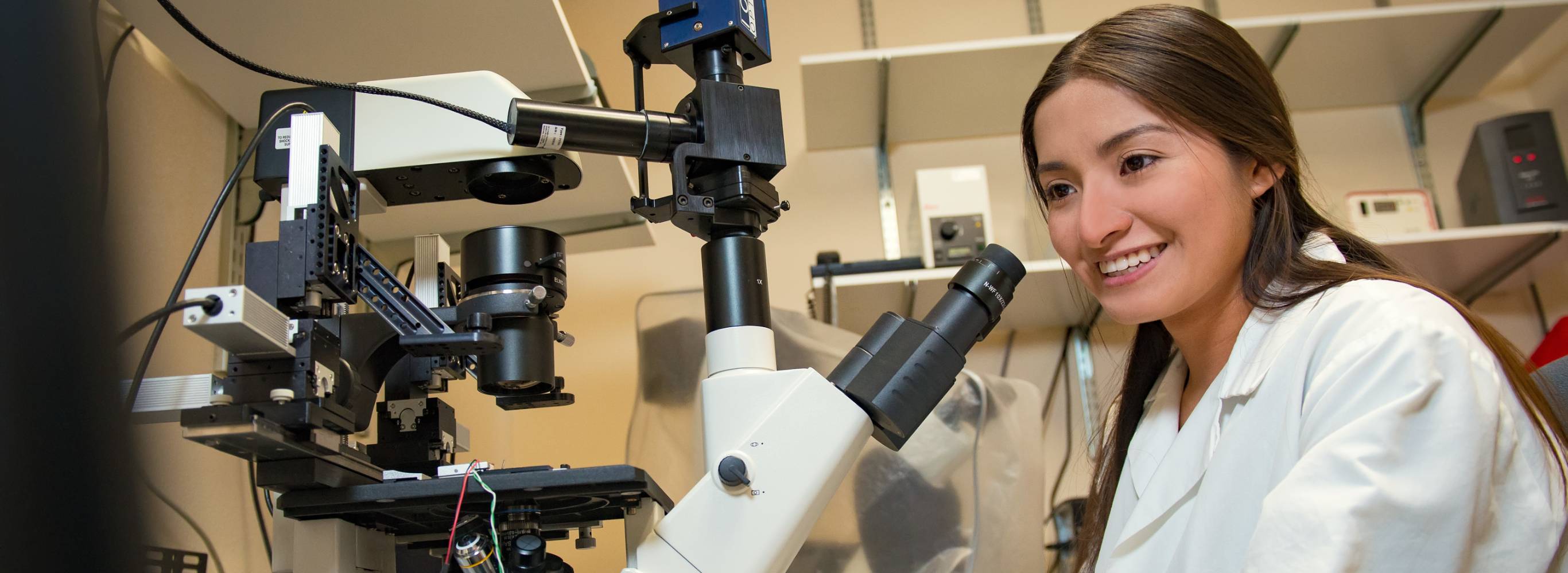 student using a microscope